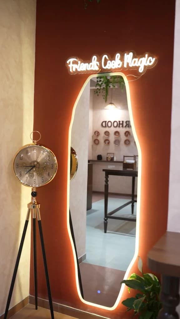 A neon-lit “Friends Cook Magic” mirror inside Benne Bros